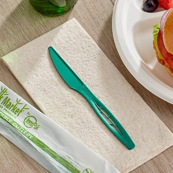 A sandwich and a Stalk Market green compostable heavy weight knife on a napkin.