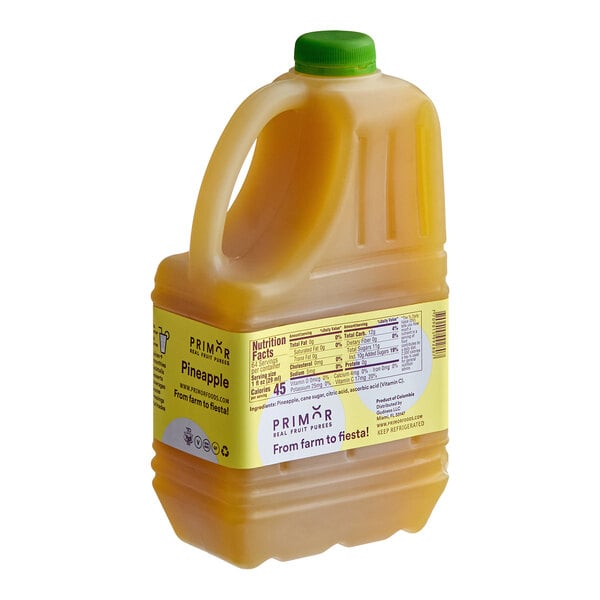 A 64 fl. oz. plastic jug of Primor pineapple puree with a green cap and a yellow label.