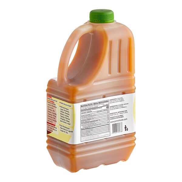 A plastic jug of Primor Peach Puree with a green cap.