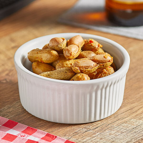 A bowl of Peanut Patch hot and spicy boiled peanuts on a table.