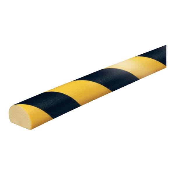 A close-up of a black and yellow striped Ideal Warehouse Knuffi surface guard.