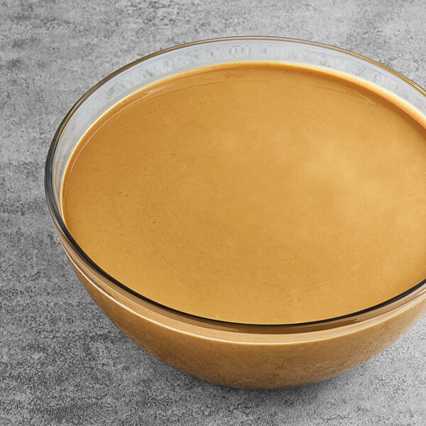 A pail of Vor sunflower butter on a table in a deli.