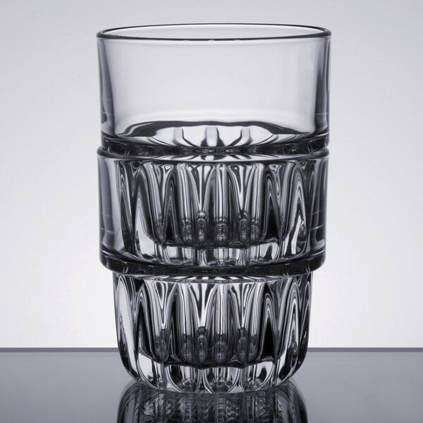 A Libbey Everest stackable rocks glass filled with water on a table.