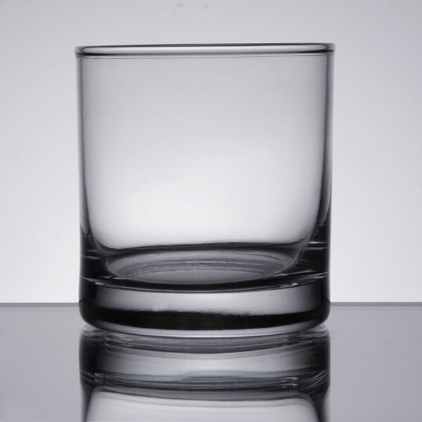 A Libbey Lexington rocks glass on a table with a reflection.