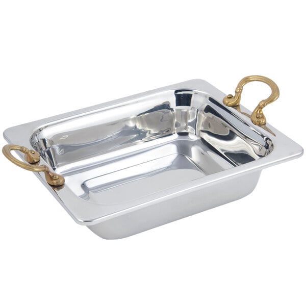 A silver rectangular food pan with round brass handles.