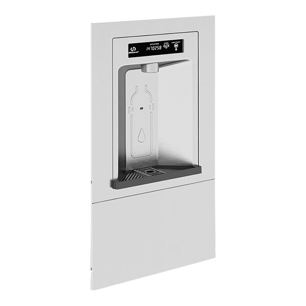 A Haws stainless steel bottle filler with a bottle in the middle.