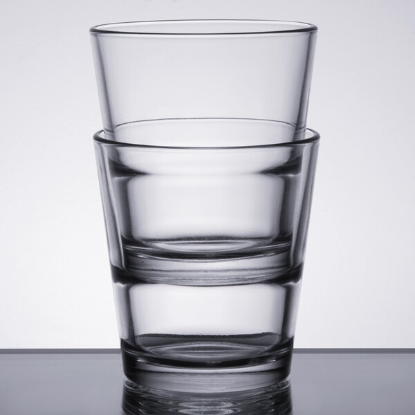 Two Libbey stackable rocks glasses on a white table.