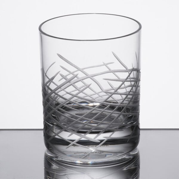 A close up of a Reserve by Libbey Crosshatch Rocks glass on a table.