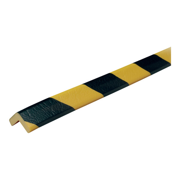 A close-up of a black and yellow striped Ideal Warehouse Knuffi corner guard.