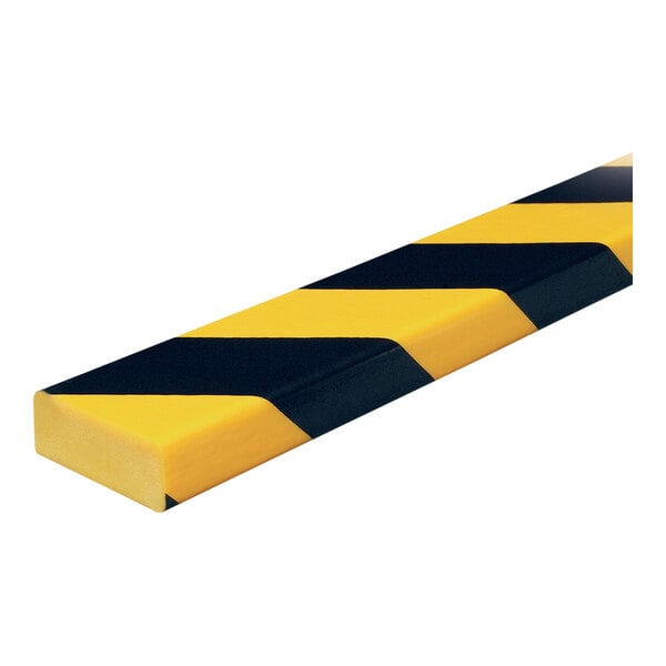 A close-up of a yellow and black striped Ideal Warehouse Knuffi surface guard.