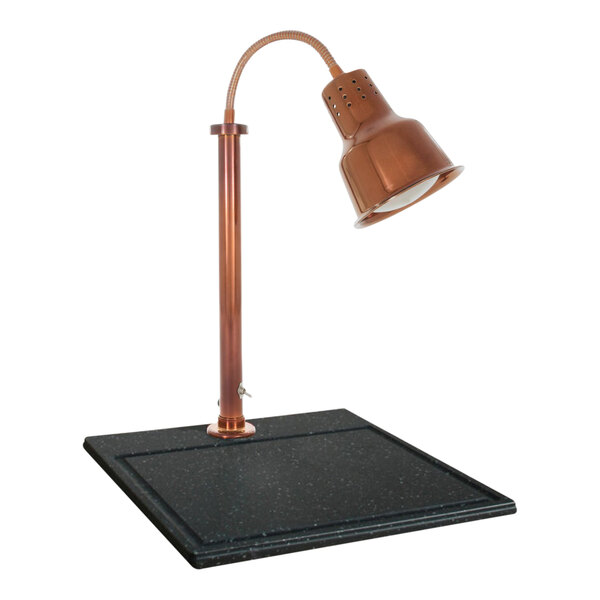 A Hanson copper carving station lamp on a black square surface.