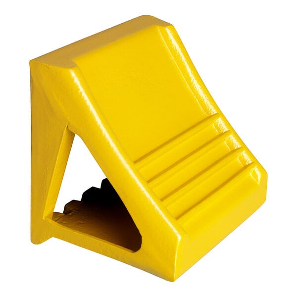 A yellow cast ductile iron wheel chock with a handle.