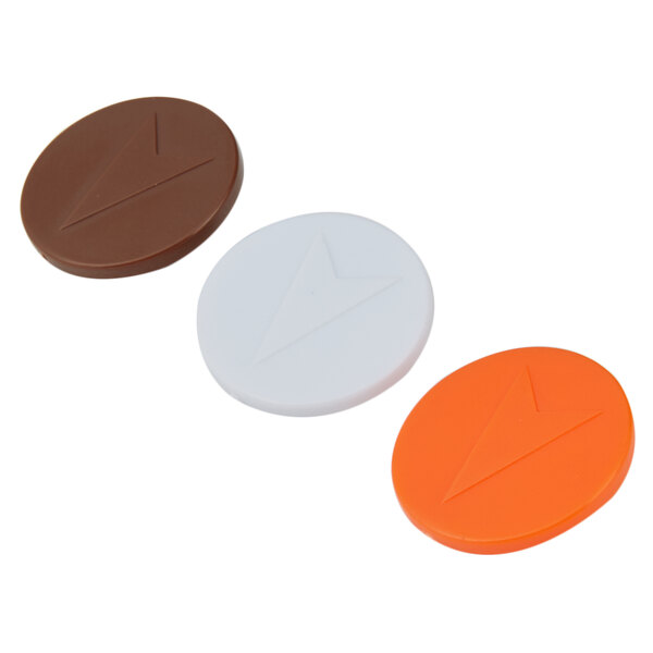 A group of three round plastic caps, each with a different color and a white or orange circle with a triangle design.