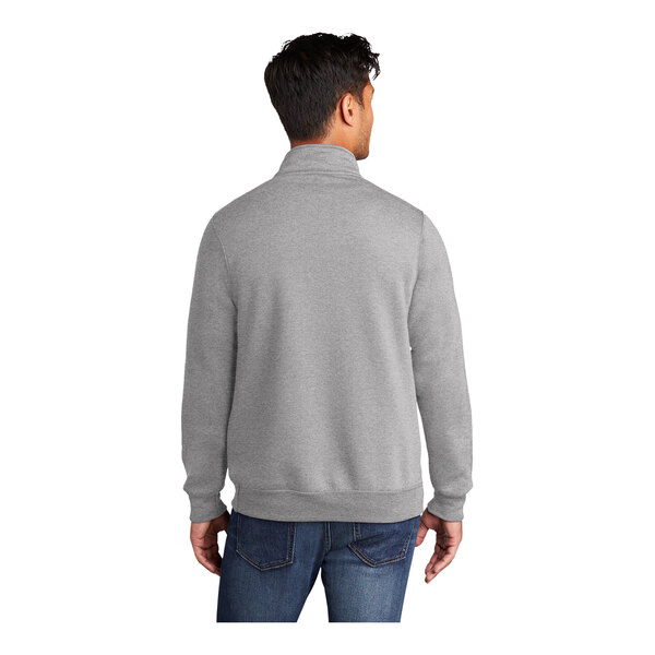 A man wearing a Port & Company Core Fleece Quarter-Zip Pullover in athletic heather.