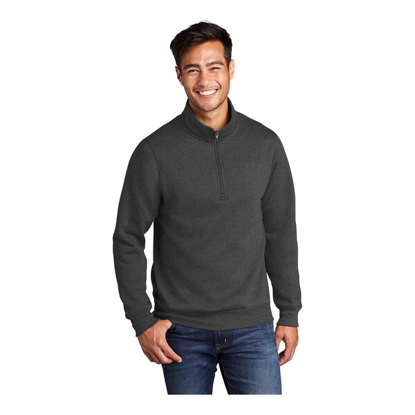 A man wearing a dark heather gray Port & Company quarter-zip pullover.