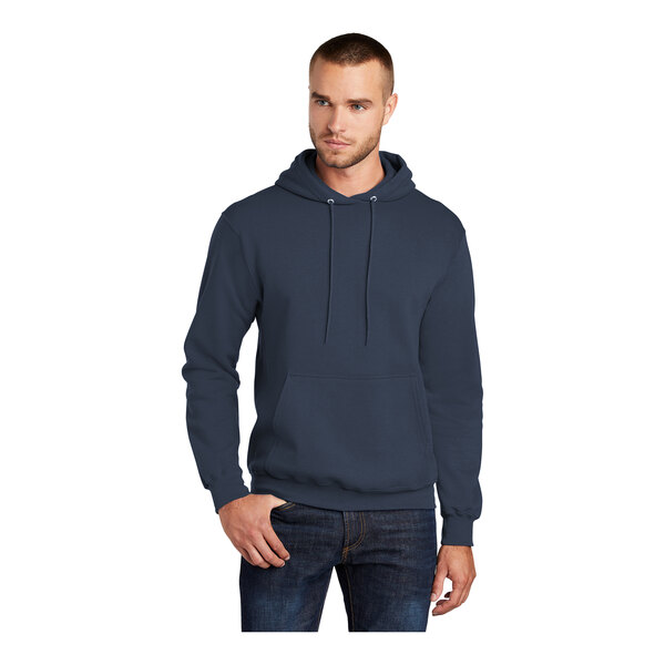 A man wearing a navy Port & Company Core Fleece pullover hoodie.