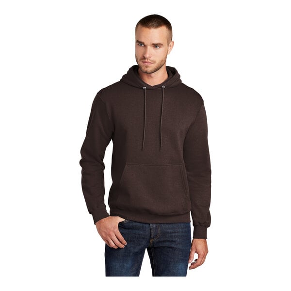 A man wearing a dark brown Port & Company Core Fleece pullover hoodie.