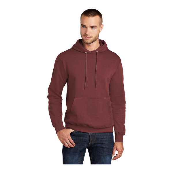 A man wearing a maroon Port & Company hooded sweatshirt.