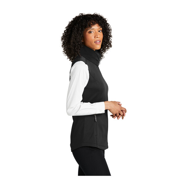 A woman wearing a deep black Port Authority fleece vest.