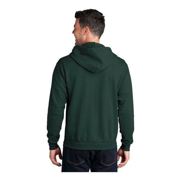A man wearing a dark green Port & Company full-zip hoodie.