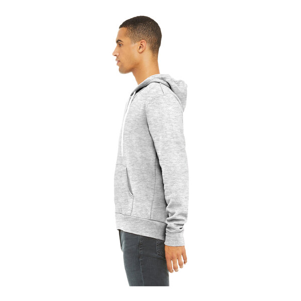 A man wearing a Bella + Canvas ash grey sponge fleece full-zip hoodie.