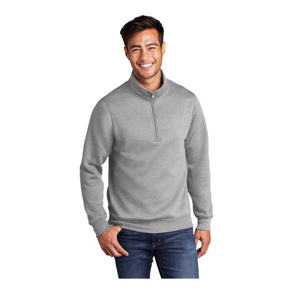 A man wearing a Port & Company athletic heather quarter-zip pullover sweatshirt.