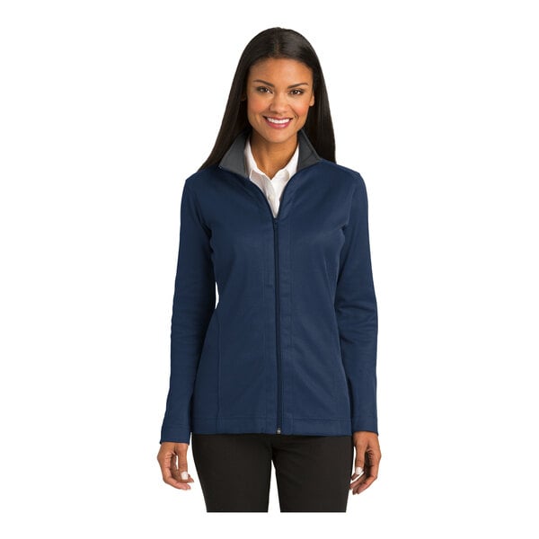 A woman wearing a Port Authority regatta blue and iron gray full-zip jacket with vertical texture.