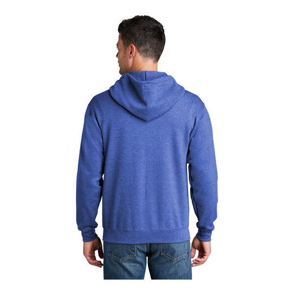 A man wearing a heather royal blue Port & Company Core Fleece full-zip hoodie.