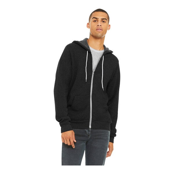 A man wearing a black zip up Bella + Canvas hoodie.