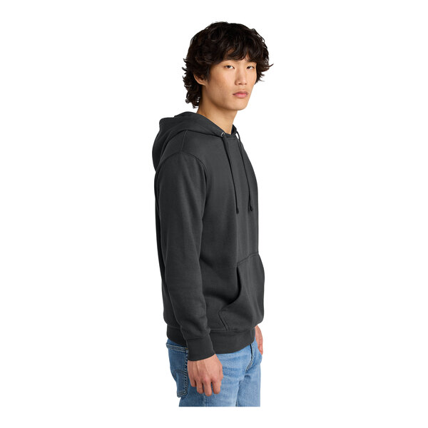 A man wearing a charcoal District sweatshirt hoodie.