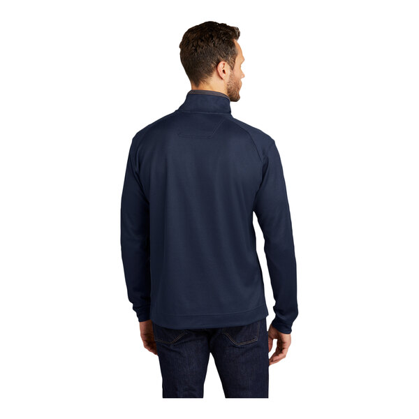 A man wearing a Port Authority navy blue quarter-zip pullover with long sleeves.