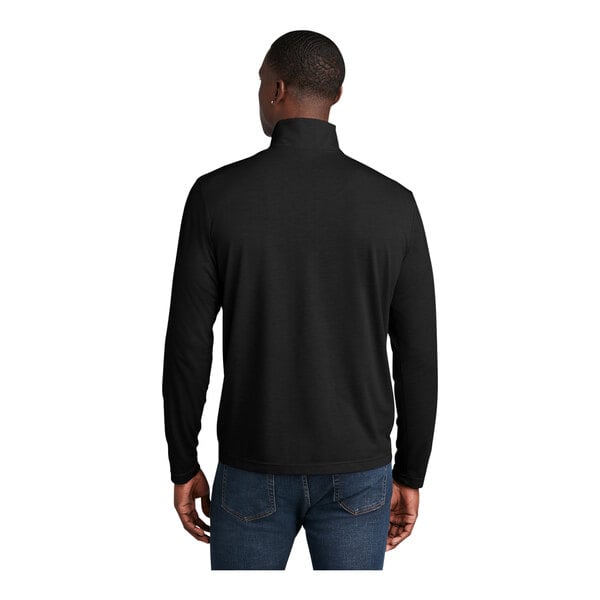 A man wearing a Sport-Tek black quarter-zip pullover sweatshirt.