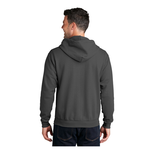 A man wearing a charcoal Port & Company Core Fleece full-zip hoodie.