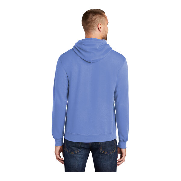 A man wearing a Carolina blue Port & Company core fleece pullover hoodie.