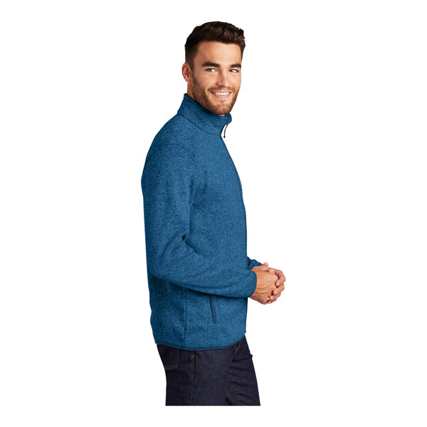 A man wearing a medium blue Port Authority fleece sweater jacket with a full-zip.