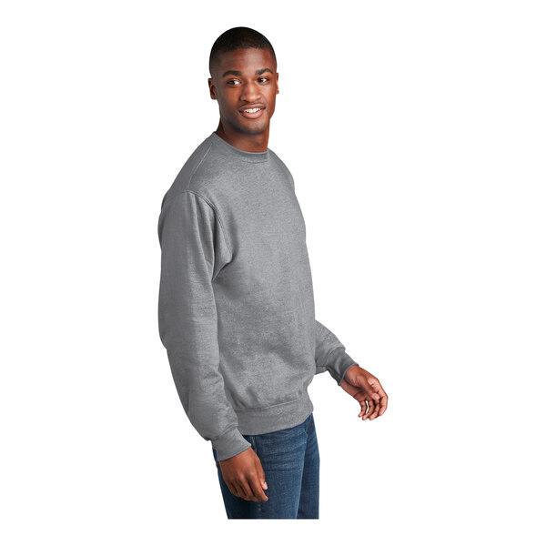 A man wearing an Athletic Heather Port & Company core fleece sweatshirt smiling.
