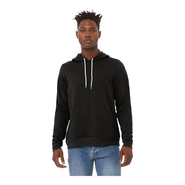 A man wearing a Bella + Canvas black sponge fleece pullover hoodie.