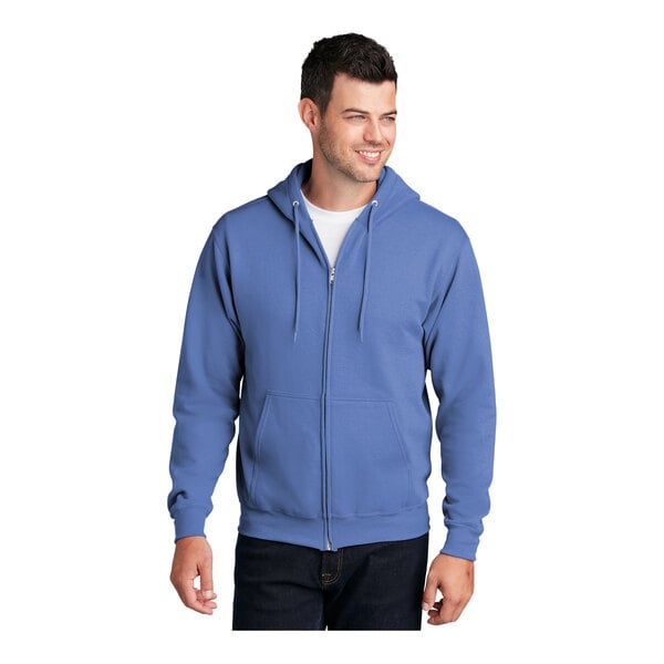 A man wearing a Carolina blue Port & Company full-zip hoodie sweatshirt.