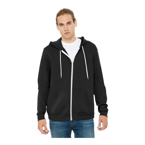 A man wearing a black Bella + Canvas zip-up hoodie.