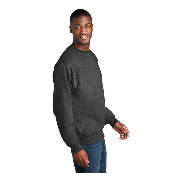 A man wearing a dark heather gray Port & Company core fleece sweatshirt smiling.