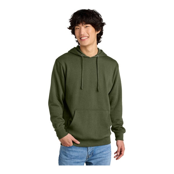 A man wearing an olive District sweatshirt with a hood.