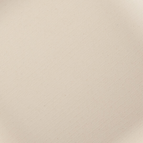 A close up of a papyrus-colored square plate with a fabric surface.