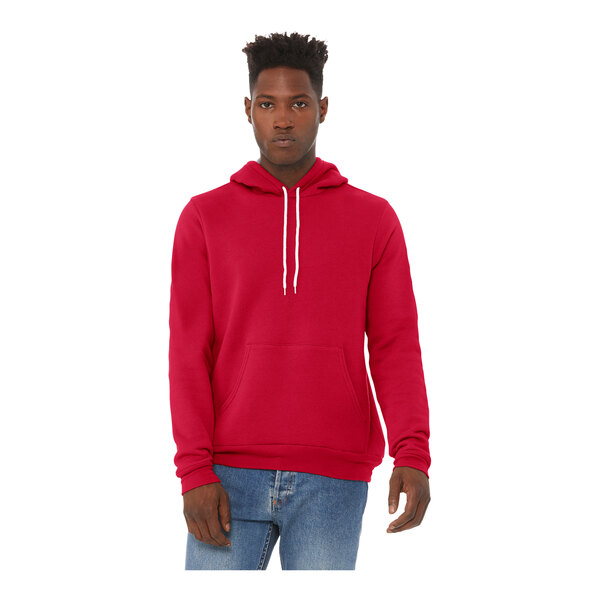 A man wearing a red Bella + Canvas pullover hoodie.