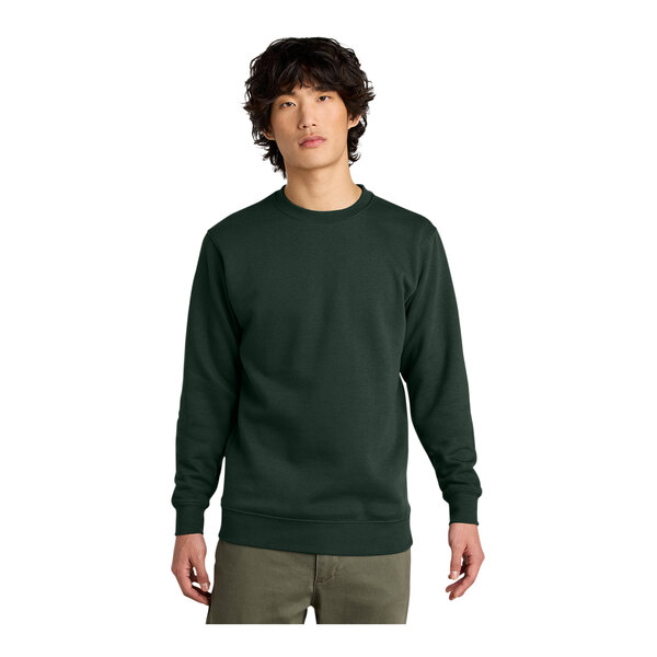 A man wearing a District forest green fleece crewneck sweatshirt.