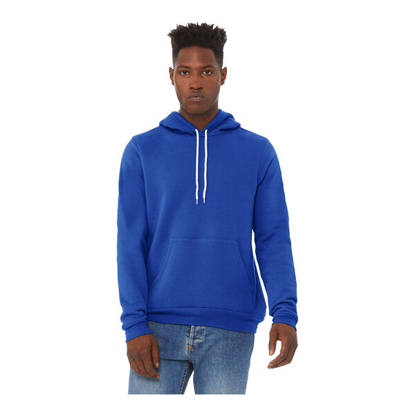 A man wearing a Bella + Canvas blue sponge fleece pullover hoodie.