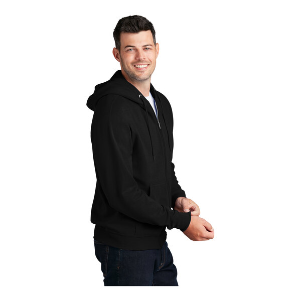 A man wearing a black Port & Company full-zip hoodie.