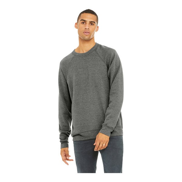 A man wearing a Bella + Canvas grey triblend sweatshirt with jeans.