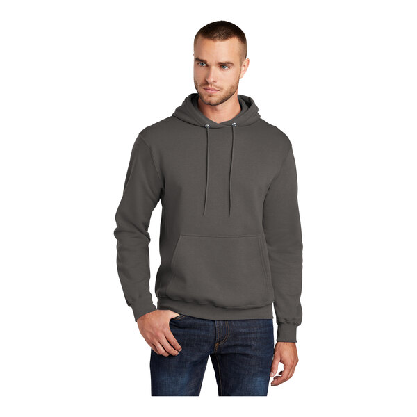 A man wearing a Port & Company charcoal core fleece pullover hoodie sweatshirt.