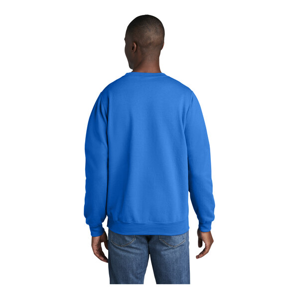 A man wearing a royal blue Port & Company core fleece sweatshirt.