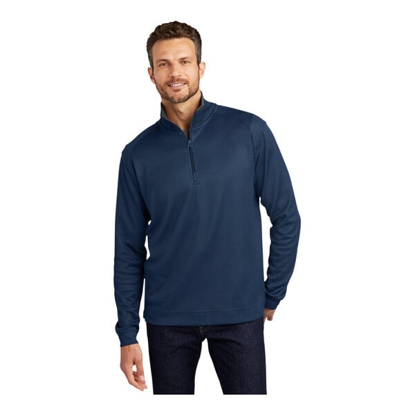 A man in a Port Authority regatta blue and iron gray quarter-zip pullover sweater.